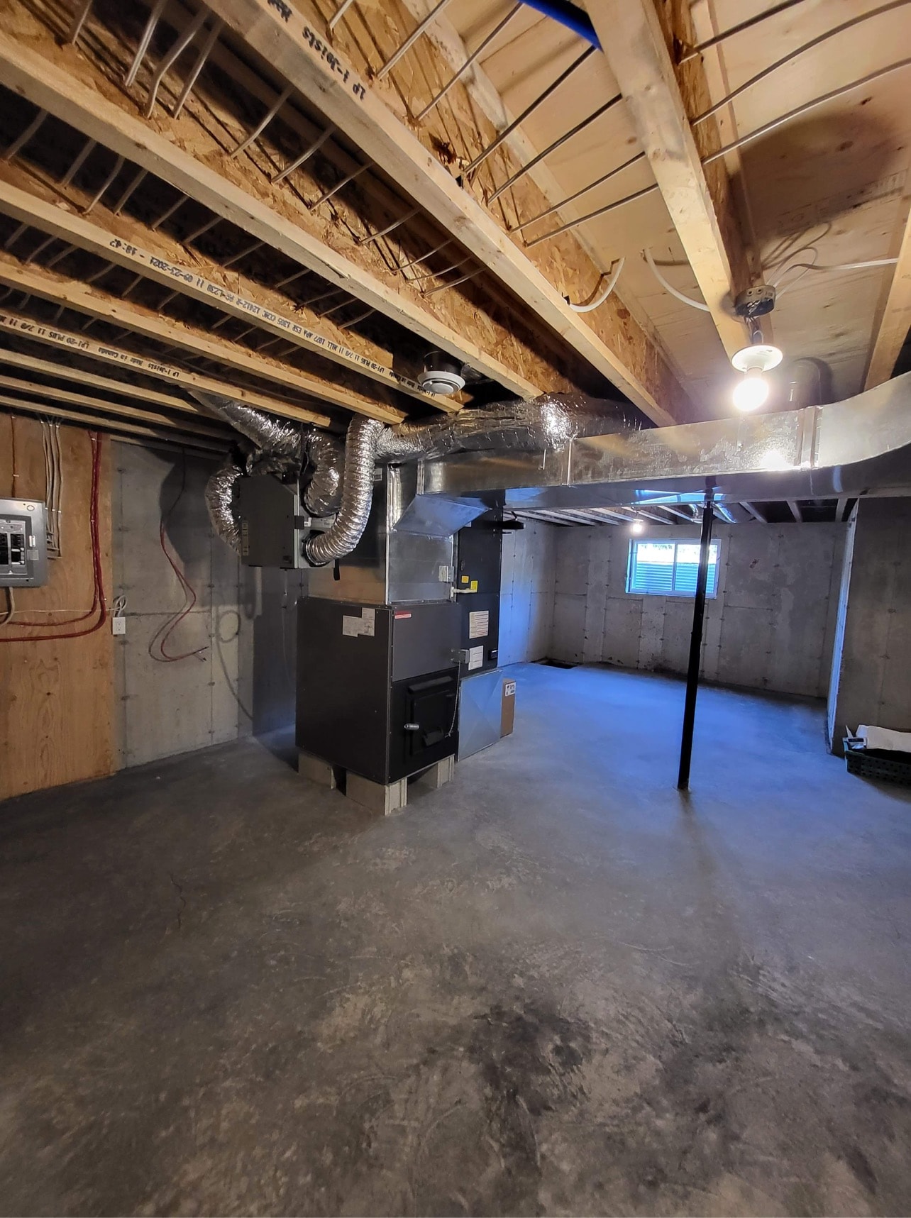 Central heat pump system and ductwork in unfinished basement
