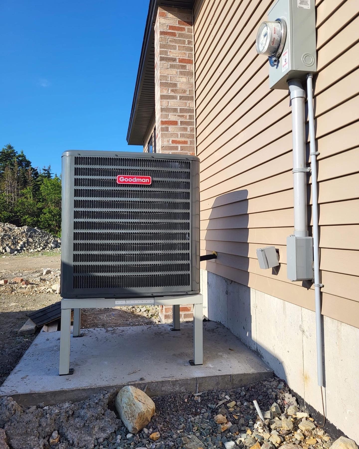 Goodman central heat pump outdoor unit on concrete pad