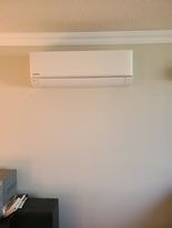Mini split indoor wall unit cleanly mounted in bedroom