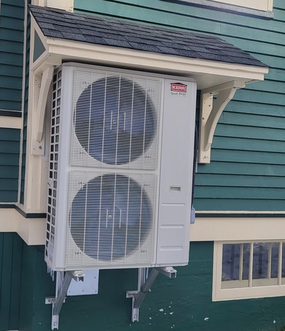 Kerr heat pump outdoor unit with custom shelter — professional installation by Butler's HVAC