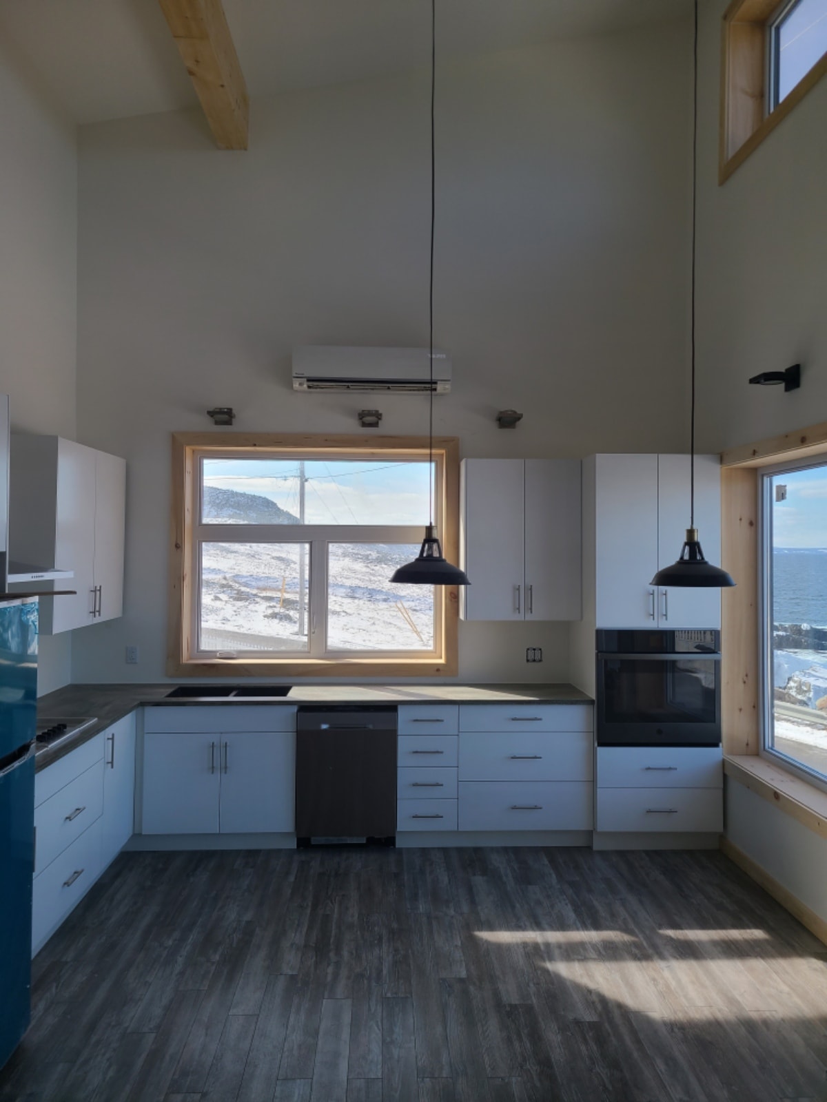 Mini split indoor head unit installed in modern kitchen with ocean view
